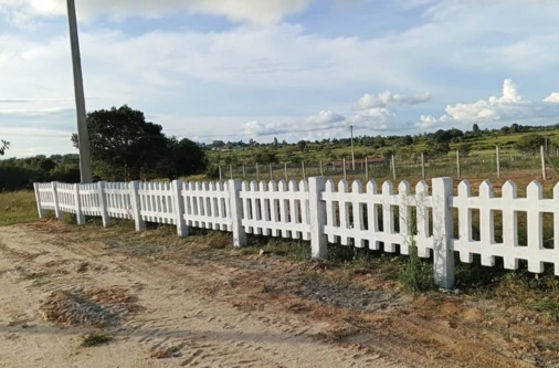 White picket fencing amenity at Sangam Farms farmland project ensuring secure and well-planned agricultural plots