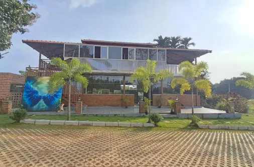 Modern restaurant in managed farmland project near Hosur surrounded by greenery and cultivated land
