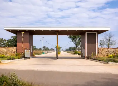 Main entrance gate of Tamara Valley farmland project with wide internal roads and premium layout